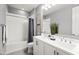 Bright bathroom featuring a dual sink vanity, a shower-tub combination, and neutral gray walls at 7472 E Paraiso Dr, Scottsdale, AZ 85255
