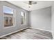 Bedroom featuring two windows, wood-look floors, and neutral walls, creating a relaxing atmosphere at 7472 E Paraiso Dr, Scottsdale, AZ 85255