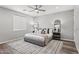 Stylish primary bedroom with plush bed, modern light fixtures, a ceiling fan and wood floors at 7472 E Paraiso Dr, Scottsdale, AZ 85255