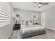 Stylish primary bedroom with plush bed, modern light fixtures, a ceiling fan and wood floors at 7472 E Paraiso Dr, Scottsdale, AZ 85255