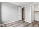 Bedroom with wood-look floors, light walls, and closet; a simple and comfortable retreat at 7472 E Paraiso Dr, Scottsdale, AZ 85255
