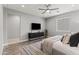 Stylish primary bedroom with media center, modern light fixtures, and wood floors at 7472 E Paraiso Dr, Scottsdale, AZ 85255