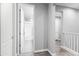 Hallway view showing neutral walls and white trim, connecting to a bathroom with tile flooring at 7472 E Paraiso Dr, Scottsdale, AZ 85255