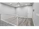 Loft area featuring wood-look floors, white railings, and ample natural light, creating an inviting space at 7472 E Paraiso Dr, Scottsdale, AZ 85255