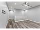 Bright loft area features wood-look flooring and neutral walls creating a versatile and inviting living space at 7472 E Paraiso Dr, Scottsdale, AZ 85255
