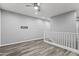 Open loft space featuring wood-look flooring, neutral walls, and ceiling fan providing versatile living area at 7472 E Paraiso Dr, Scottsdale, AZ 85255