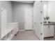 Well-lit mudroom boasts built-in bench, storage, and seamless access to the powder room and garage at 7472 E Paraiso Dr, Scottsdale, AZ 85255