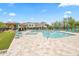 Community pool area featuring a large pool, spa, ramada, and lounging chairs, perfect for relaxation at 7472 E Paraiso Dr, Scottsdale, AZ 85255