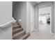 Bright staircase with wood stairs, white risers and a white handrail. Leads to an open, airy living space at 7472 E Paraiso Dr, Scottsdale, AZ 85255