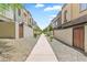 A charming row of modern townhouses, each with unique architectural details, line a walkway at 7472 E Paraiso Dr, Scottsdale, AZ 85255