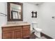 Bathroom featuring a vanity, toilet, framed mirror, and decorative shelves at 8132 E 3Rd Ave, Mesa, AZ 85208