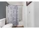 Clean bathroom with a shower-tub combo and patterned shower curtain at 8132 E 3Rd Ave, Mesa, AZ 85208