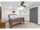 Bright bedroom featuring a wooden bed frame, neutral carpet and a modern ceiling fan at 8132 E 3Rd Ave, Mesa, AZ 85208