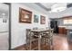 Open-concept dining area with stylish table and chairs, and decorative framed art at 8132 E 3Rd Ave, Mesa, AZ 85208