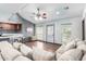 Comfortable living room with modern ceiling fan and smooth transition to the kitchen area at 8132 E 3Rd Ave, Mesa, AZ 85208