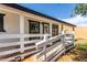 Inviting front porch with white railing and wood accents, offering a charming entrance at 8132 E 3Rd Ave, Mesa, AZ 85208