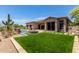 Beautiful backyard with artificial turf, a pool, spa, and desert landscaping; great for outdoor relaxation at 8725 E Menlo Cir, Mesa, AZ 85207
