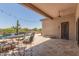 Charming backyard featuring a covered patio with seating, a refreshing pool, and desert landscaping, ideal for entertaining at 8725 E Menlo Cir, Mesa, AZ 85207