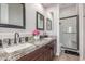 Elegant bathroom featuring dual vanities with granite countertops and a separate shower at 8725 E Menlo Cir, Mesa, AZ 85207