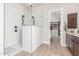 Luxurious bathroom featuring glass shower, granite vanity and walk-in closet at 8725 E Menlo Cir, Mesa, AZ 85207