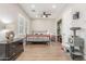 Bright bedroom with wood-look flooring, ceiling fan, walk-in closet and comfortable furniture at 8725 E Menlo Cir, Mesa, AZ 85207