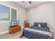 Comfortable bedroom with natural light, wood-look flooring, and modern furnishings at 8725 E Menlo Cir, Mesa, AZ 85207
