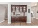Custom buffet cabinet featuring granite countertops, and decorative glassware at 8725 E Menlo Cir, Mesa, AZ 85207