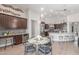 Charming dining area with table, chairs, built in cabinet, and open view of kitchen at 8725 E Menlo Cir, Mesa, AZ 85207
