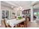 Light-filled dining room boasting an elegant chandelier, stylish wooden floors, and a built-in buffet at 8725 E Menlo Cir, Mesa, AZ 85207
