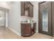 Welcoming entryway with granite countertop, custom cabinets, and decorative glass door at 8725 E Menlo Cir, Mesa, AZ 85207