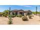 Charming home featuring desert landscaping, stone accents, and a well-maintained front yard at 8725 E Menlo Cir, Mesa, AZ 85207