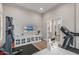 Comfortable home gym featuring neutral tones, a wall-mounted TV, and convenient access to other rooms at 8725 E Menlo Cir, Mesa, AZ 85207