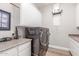 Well-equipped laundry room with modern washer and dryer, ample counter space, and overhead cabinets for organized storage at 8725 E Menlo Cir, Mesa, AZ 85207