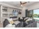 Comfortable living room featuring a decorative fireplace and an access to the backyard swimming pool at 8725 E Menlo Cir, Mesa, AZ 85207