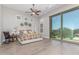 Bright main bedroom with a sliding glass door, ceiling fan, and a cozy rocking chair at 8725 E Menlo Cir, Mesa, AZ 85207