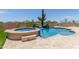 Stunning pool and spa featuring desert landscaping and a waterfall feature, creating a luxurious outdoor retreat at 8725 E Menlo Cir, Mesa, AZ 85207
