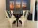 Dining area with a modern table and chairs, decorated with colorful artwork at 9451 E Becker Ln # 1051, Scottsdale, AZ 85260