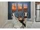 The dining area features a glass top table, views of the kitchen, and cactus-themed art at 9451 E Becker Ln # 1051, Scottsdale, AZ 85260