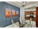 The dining area features a glass top table, views of the kitchen, and cactus-themed art at 9451 E Becker Ln # 1051, Scottsdale, AZ 85260