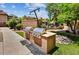 Community outdoor grill featuring two gas grills and manicured landscaping with rocks and walkway at 9451 E Becker Ln # 1051, Scottsdale, AZ 85260