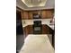 Kitchen features granite counters, stainless steel appliances, wood cabinets and white tile floors at 9451 E Becker Ln # 1051, Scottsdale, AZ 85260