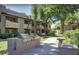 Community outdoor grill area with two barbecue grills and concrete counter space at 9451 E Becker Ln # 1051, Scottsdale, AZ 85260
