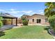 This backyard features a grassy lawn, a gazebo, and a landscaped perimeter, creating a relaxing outdoor space at 973 E Kelsi Ave, San Tan Valley, AZ 85140