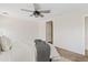 Bedroom features a ceiling fan, comfortable bed, and a door that leads to another room at 973 E Kelsi Ave, San Tan Valley, AZ 85140