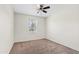 Bright, neutral bedroom with carpet flooring, a ceiling fan, and a window with natural light at 973 E Kelsi Ave, San Tan Valley, AZ 85140