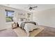 Cozy bedroom with a ceiling fan, two windows that allow natural light, and a comfortable bed at 973 E Kelsi Ave, San Tan Valley, AZ 85140
