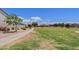 Community park featuring a large grassy area, walking path, and mature trees, perfect for outdoor activities at 973 E Kelsi Ave, San Tan Valley, AZ 85140