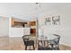 This dining room showcases a modern glass table, decorative art, and neutral walls leading to a well-equipped kitchen at 973 E Kelsi Ave, San Tan Valley, AZ 85140