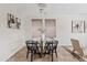 Dining room featuring a glass table, black chairs, and modern decor at 973 E Kelsi Ave, San Tan Valley, AZ 85140