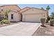 Charming single-level home with a two-car garage, neutral paint, and desert-friendly front yard at 973 E Kelsi Ave, San Tan Valley, AZ 85140